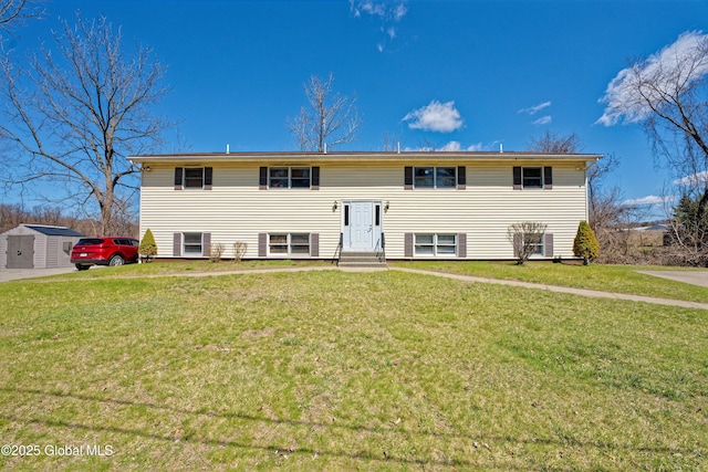 view of front of home featuring an outdoor structure, a front lawn, a shed, and entry steps