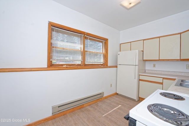kitchen with a sink, white appliances, baseboards, light countertops, and a baseboard radiator