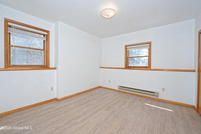 unfurnished room with baseboards, a baseboard heating unit, and wood finished floors