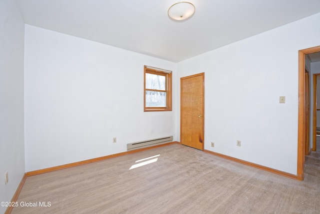 unfurnished room featuring baseboards, a baseboard radiator, and wood finished floors