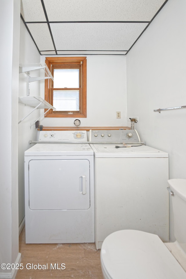 laundry room featuring separate washer and dryer, laundry area, and light wood-type flooring