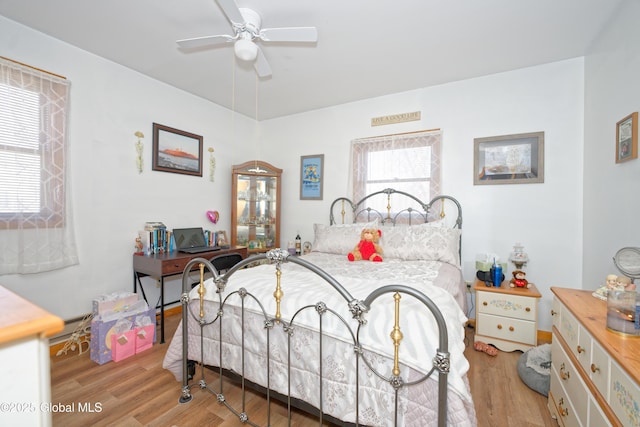bedroom featuring a ceiling fan and wood finished floors
