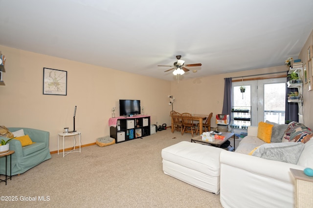 living room with carpet floors and a ceiling fan