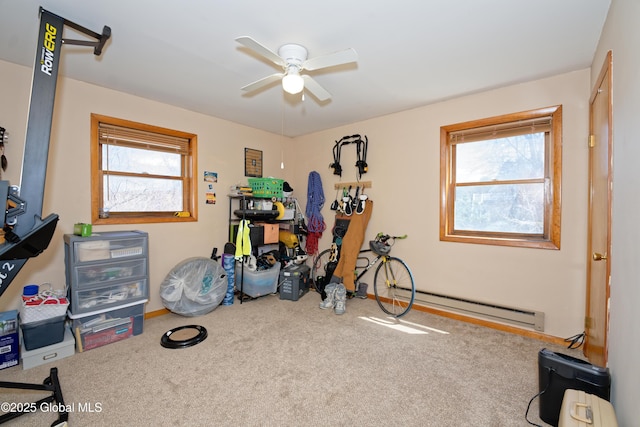 interior space with ceiling fan, plenty of natural light, carpet, and a baseboard radiator