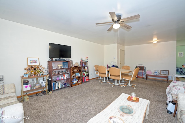 carpeted living room with baseboards and a ceiling fan