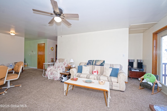 living area featuring carpet flooring and a ceiling fan