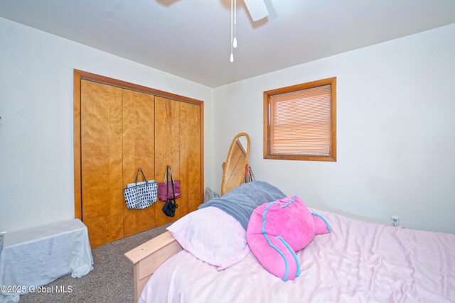 carpeted bedroom featuring a closet and ceiling fan