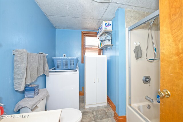 full bath featuring a paneled ceiling, shower / bath combination with glass door, baseboards, and toilet