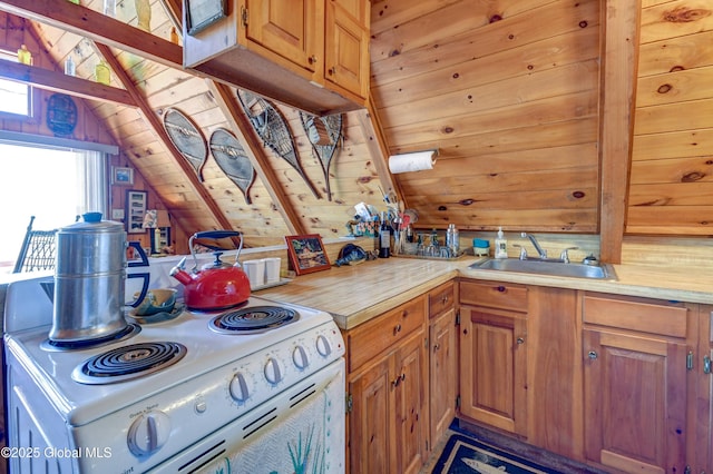 kitchen with a sink, light countertops, lofted ceiling, and electric stove