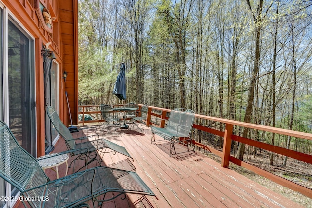 wooden terrace with outdoor dining area