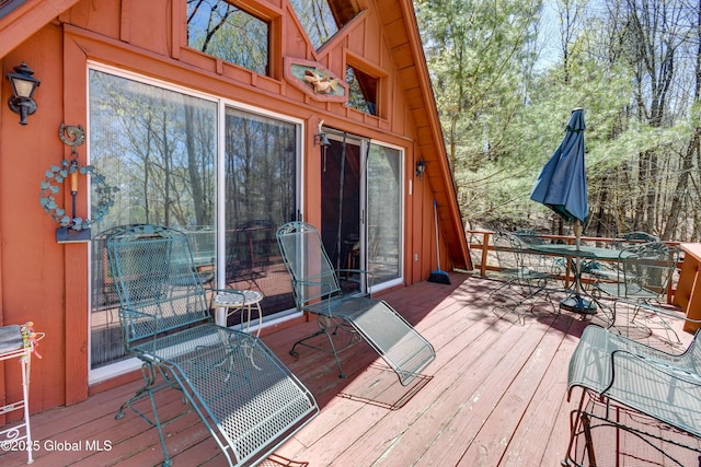 wooden terrace with outdoor dining area