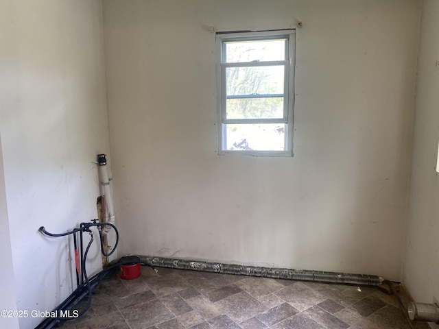 18751 State Route 22, Petersburgh, NY 12138 - unfurnished room featuring healthy amount of natural light and dark stone finish floors