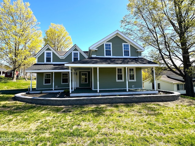 view of front of home featuring a front yard, a porch, and a shingled roof