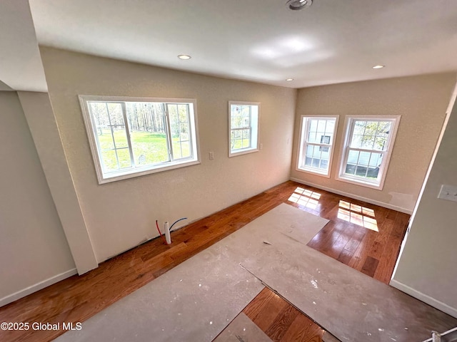 spare room featuring recessed lighting and wood finished floors