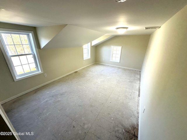 bonus room with visible vents, baseboards, and lofted ceiling