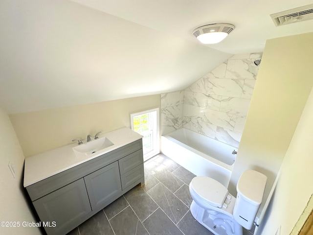 full bath with toilet, marble finish floor, visible vents, vanity, and vaulted ceiling