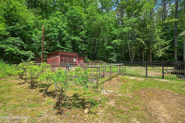 175 Library Ave, Warrensburg, NY 12885 - view of yard featuring an outdoor structure, a vegetable garden, and a forest view