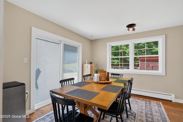 175 Library Ave, Warrensburg, NY 12885 - dining area featuring a baseboard heating unit and wood finished floors