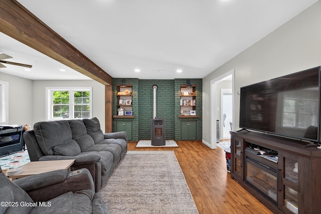 175 Library Ave, Warrensburg, NY 12885 - living area featuring a wood stove, light wood-style flooring, a ceiling fan, and recessed lighting