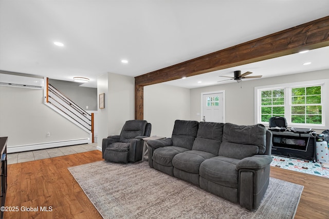 175 Library Ave, Warrensburg, NY 12885 - living area featuring a baseboard heating unit, an AC wall unit, wood finished floors, recessed lighting, and stairs