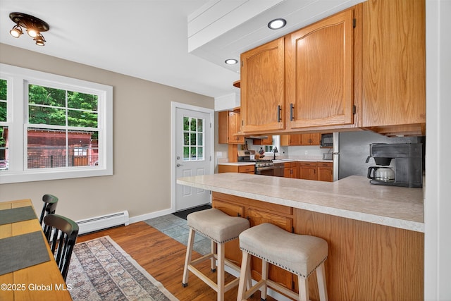 175 Library Ave, Warrensburg, NY 12885 - kitchen with gas range, healthy amount of natural light, a peninsula, and light countertops