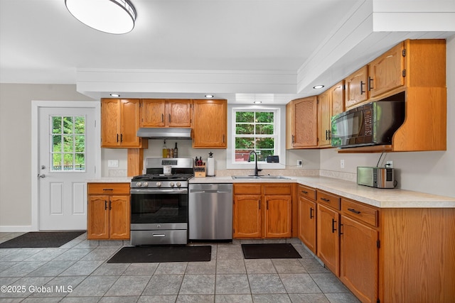 175 Library Ave, Warrensburg, NY 12885 - kitchen with stainless steel appliances, under cabinet range hood, light countertops, and plenty of natural light