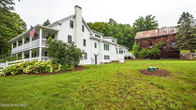 exterior space with a yard and a chimney