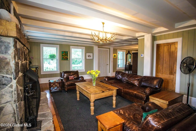 living area featuring beamed ceiling, wood walls, and a notable chandelier