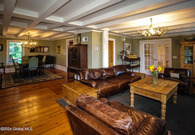 living room with an inviting chandelier, wood-type flooring, beam ceiling, french doors, and coffered ceiling