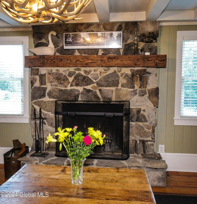 room details with wood finished floors, a chandelier, and a fireplace