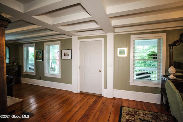 foyer entrance featuring baseboards, wood-type flooring, coffered ceiling, and beam ceiling