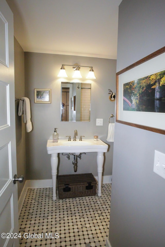 bathroom with baseboards and tile patterned floors