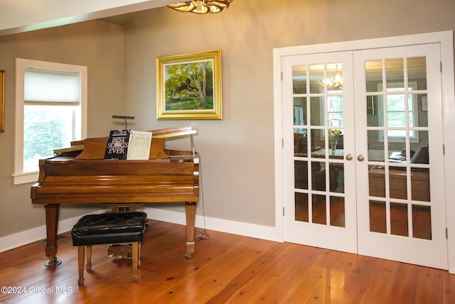 doorway with wood-type flooring, baseboards, a chandelier, and french doors