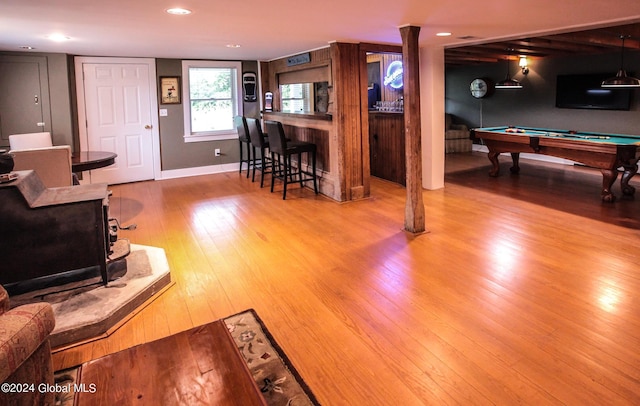 interior space featuring recessed lighting, baseboards, pool table, wood finished floors, and bar area