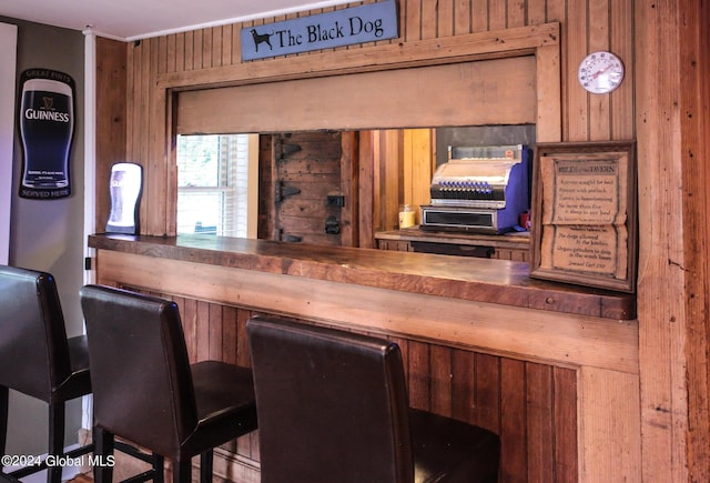 bar with wood walls and ornamental molding