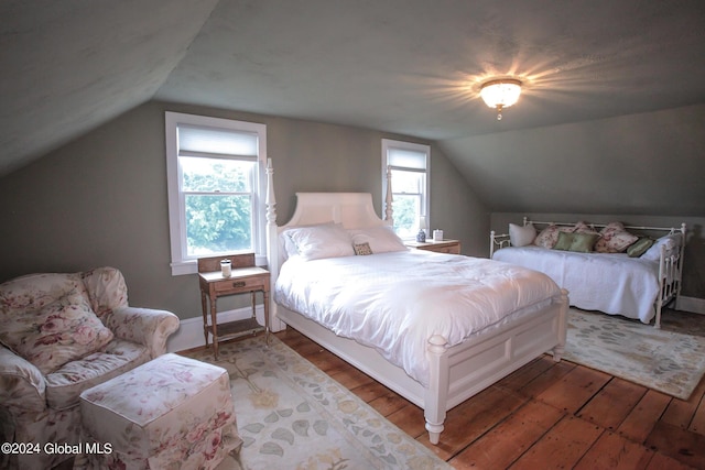 bedroom with wood-type flooring and vaulted ceiling