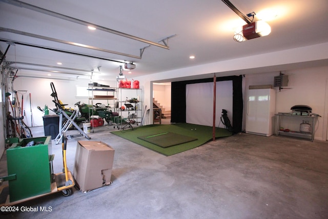 garage with recessed lighting and a garage door opener