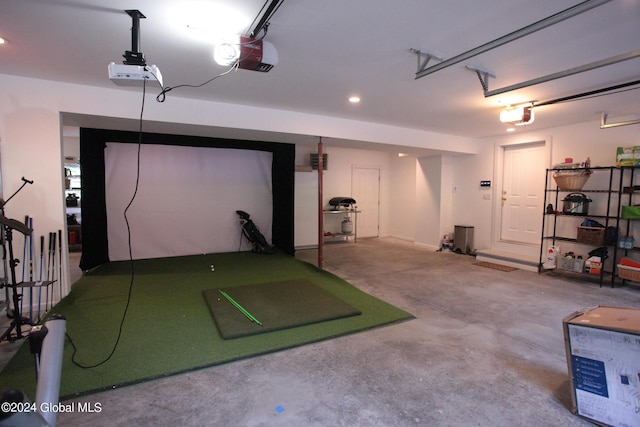 garage with recessed lighting and a garage door opener