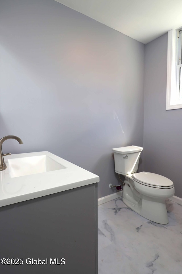 701 Engleman Ave, Glenville, NY 12302 - bathroom with toilet, vanity, marble look tile flooring, and baseboards