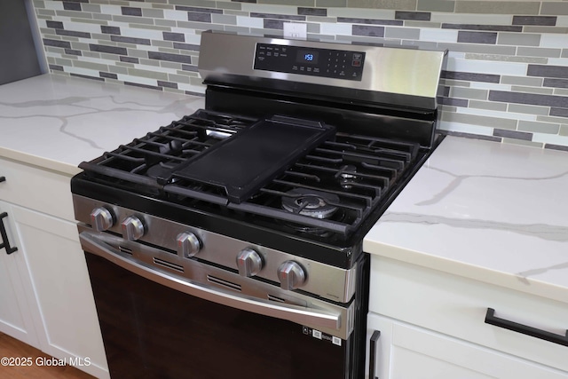 701 Engleman Ave, Glenville, NY 12302 - kitchen view of stainless steel range with gas cooktop, tasteful backsplash, and light stone countertops
