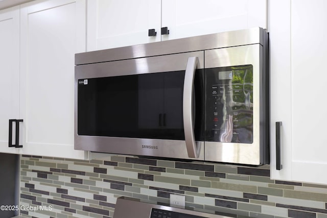 701 Engleman Ave, Glenville, NY 12302 - kitchen view of stainless steel microwave, white cabinets, and backsplash
