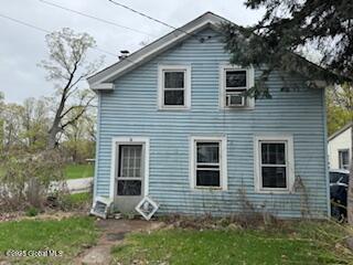 back of property with a lawn