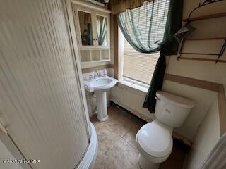 bathroom with toilet and tile patterned flooring