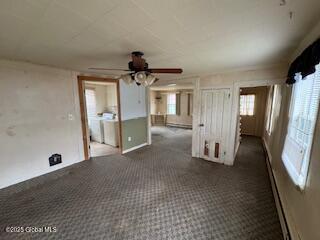 unfurnished room featuring ceiling fan and carpet