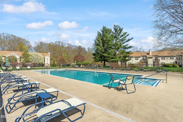 pool with fence, a residential view, and a patio area