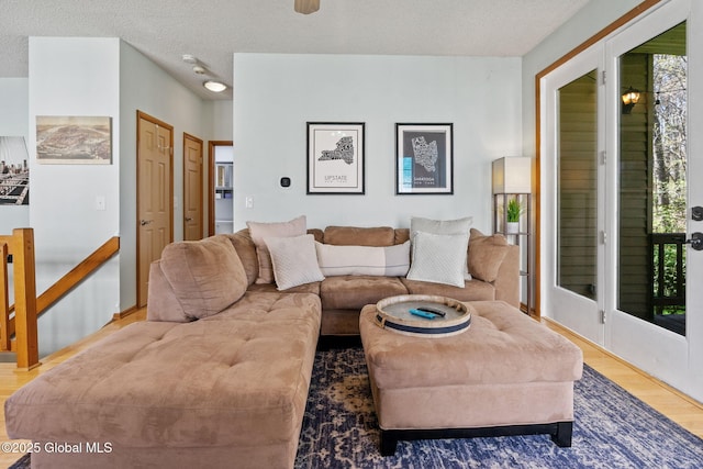 living area with a textured ceiling and wood finished floors