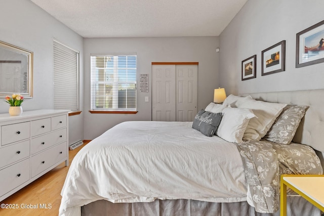 bedroom featuring light wood-style floors and a closet
