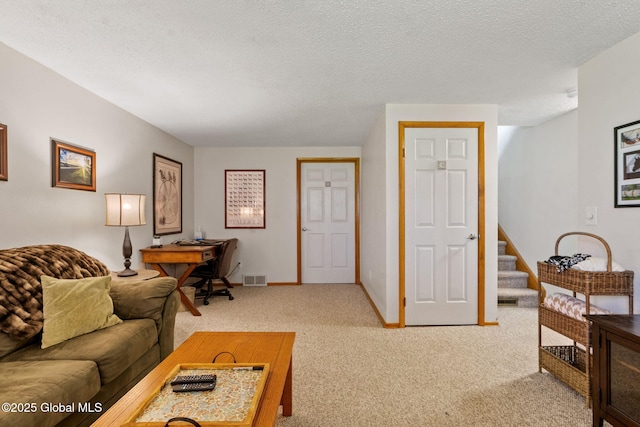 living area with baseboards, light colored carpet, a textured ceiling, and visible vents