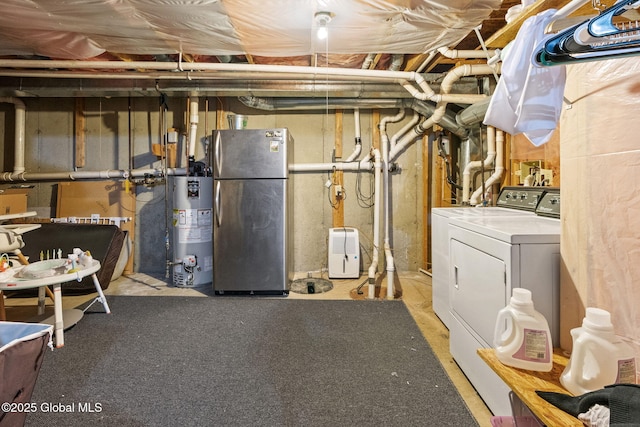 unfinished basement with gas water heater, freestanding refrigerator, and separate washer and dryer