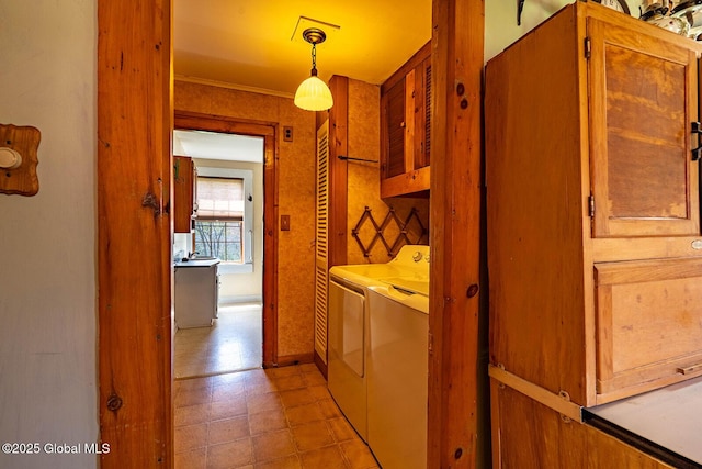 laundry area with light floors, cabinet space, baseboards, and washing machine and clothes dryer